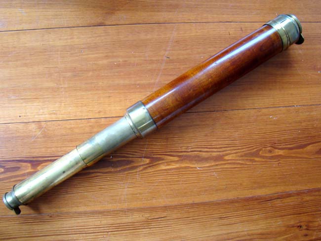 A 19th century English two-draw telescope with mahogany wrapped barrel circa 1830-1840